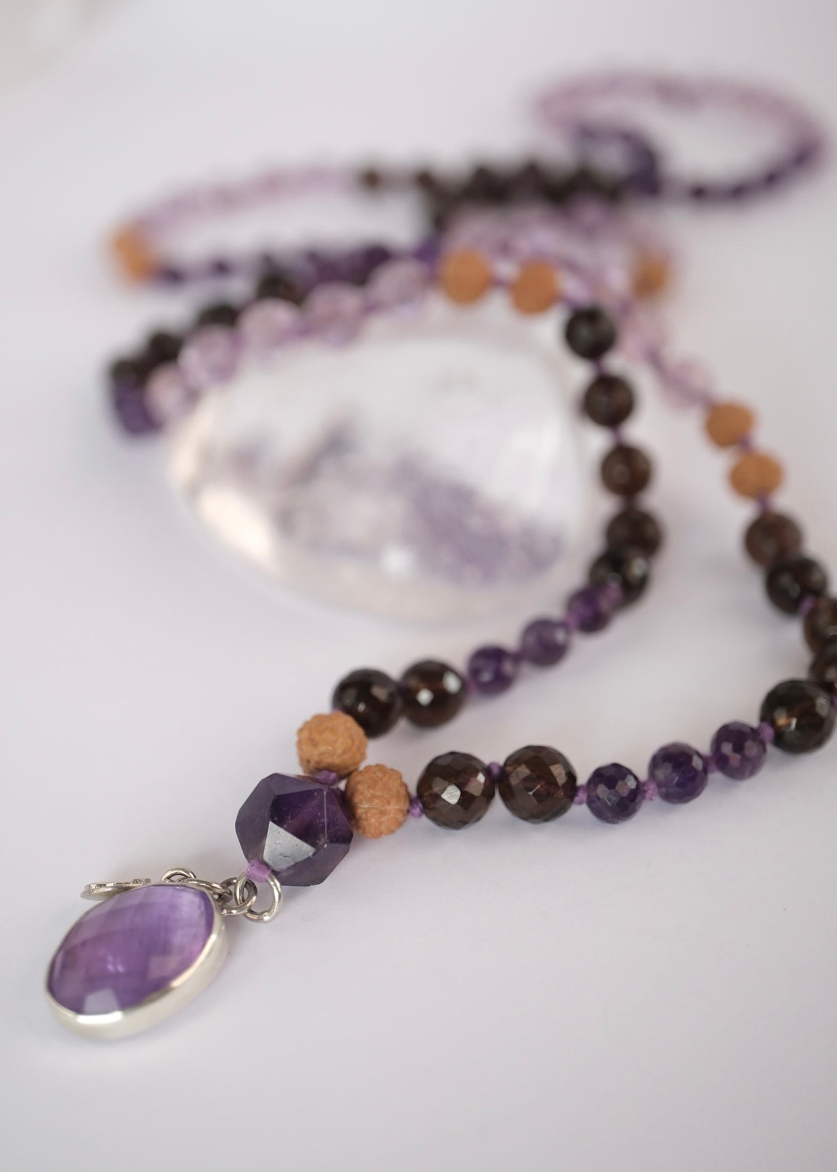 Double sided faceted amethyst pendant open at the back on the Vira Sadhaka Mala