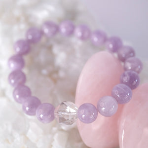Gentle lilac quartz and Herkimer bracelet soft, serene, and uplifting. ON selenite heart and surrounded by flowers