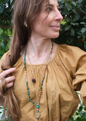 Handcrafted seer’s mala with ammonite pendant, ruby zoisite, golden rutilated quartz, malachite and Rudraksha. Blessed by the Ganga. Magic for sages and manifestation.