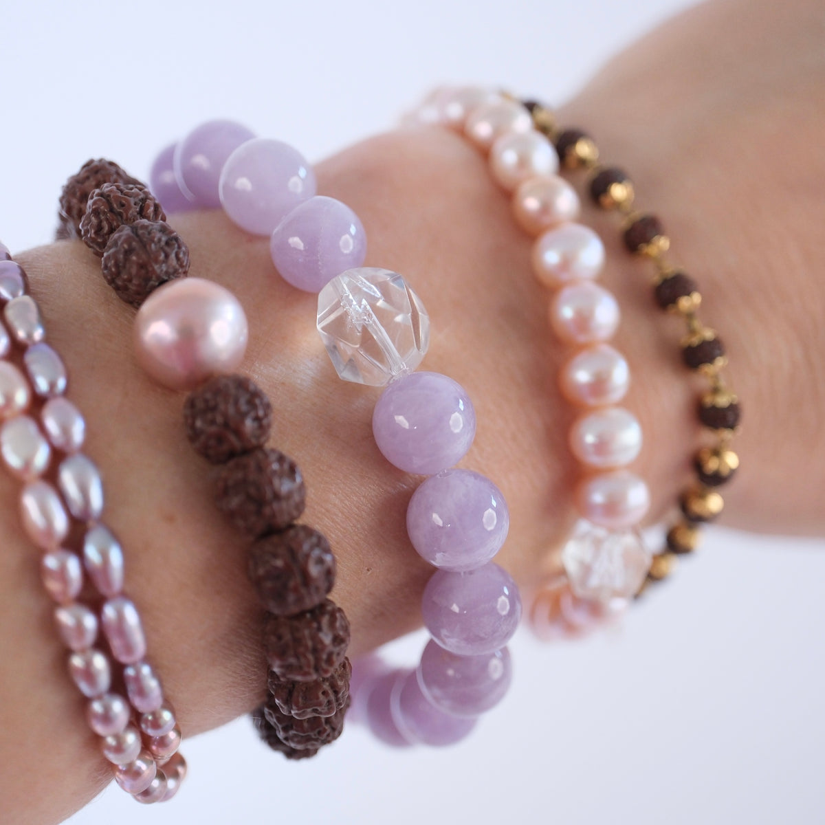 Soothing lavender quartz bracelet for peace, calm, and emotional healing, worn at the wrist with other crystal and rudraksha bracelets